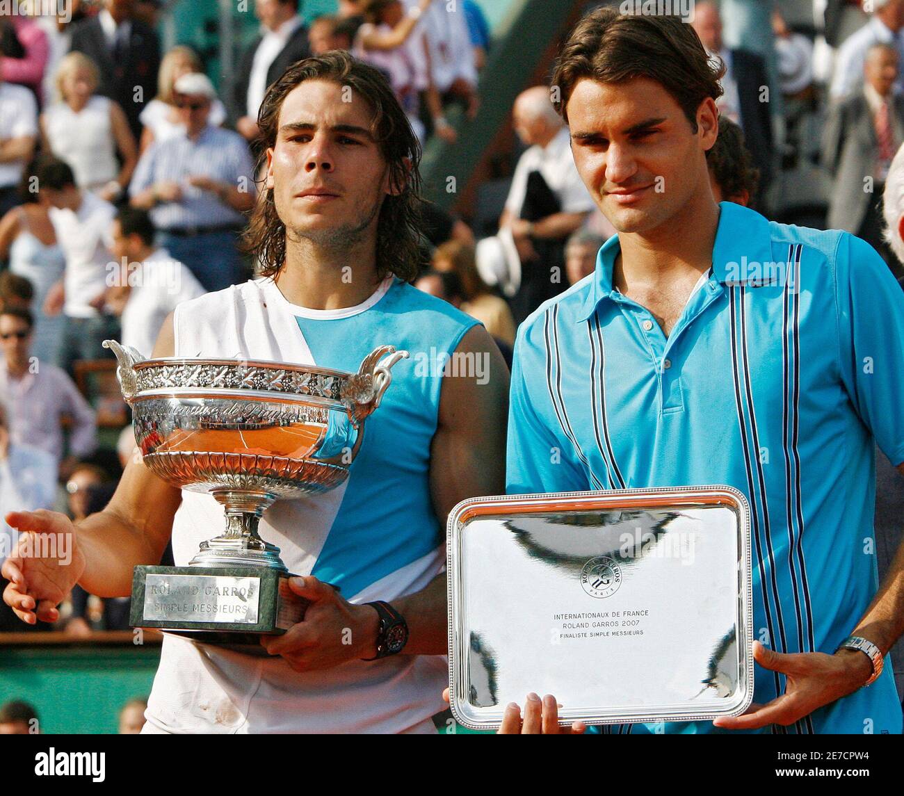 Spain's Rafael Nadal (L) stands with Switzerland's Roger Federer after  winning the men's final match at the French Open tennis tournament at Roland  Garros in Paris June 10, 2007. Nadal captured a