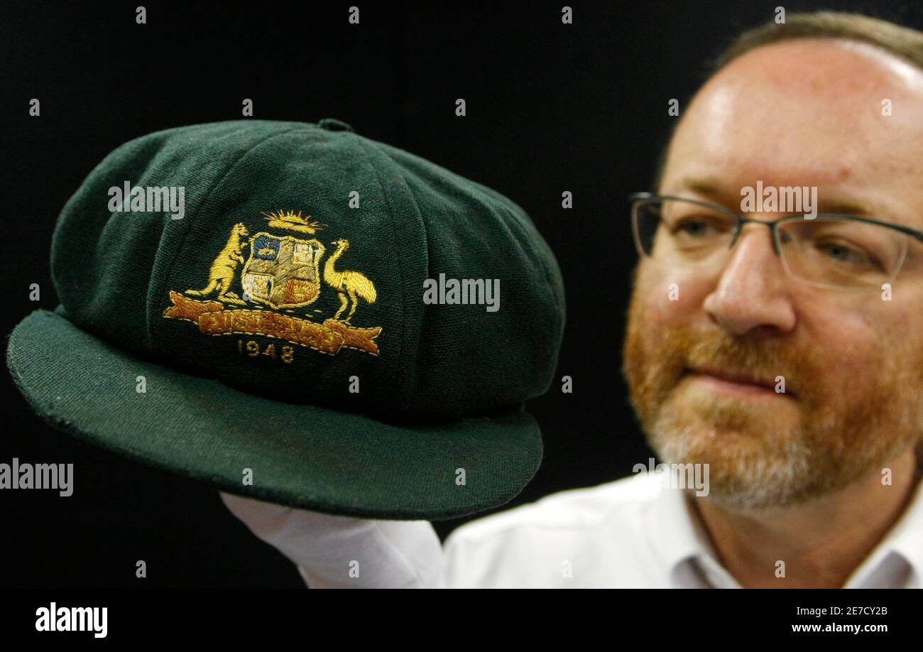 Auctioneer Charles Leski Holds Australia S Cricket Legend Sir Donald Bradman S Baggy Green 1948 Invincibles Test Match Cap In Melbourne December 2 08 Bradman S Cap Will Be Auctioned On December 15 And Is