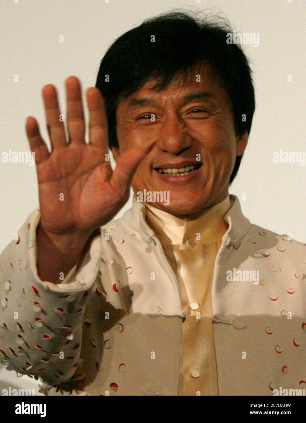 Hong Kong movie star Jackie Chan waves to fans at a promotional event
