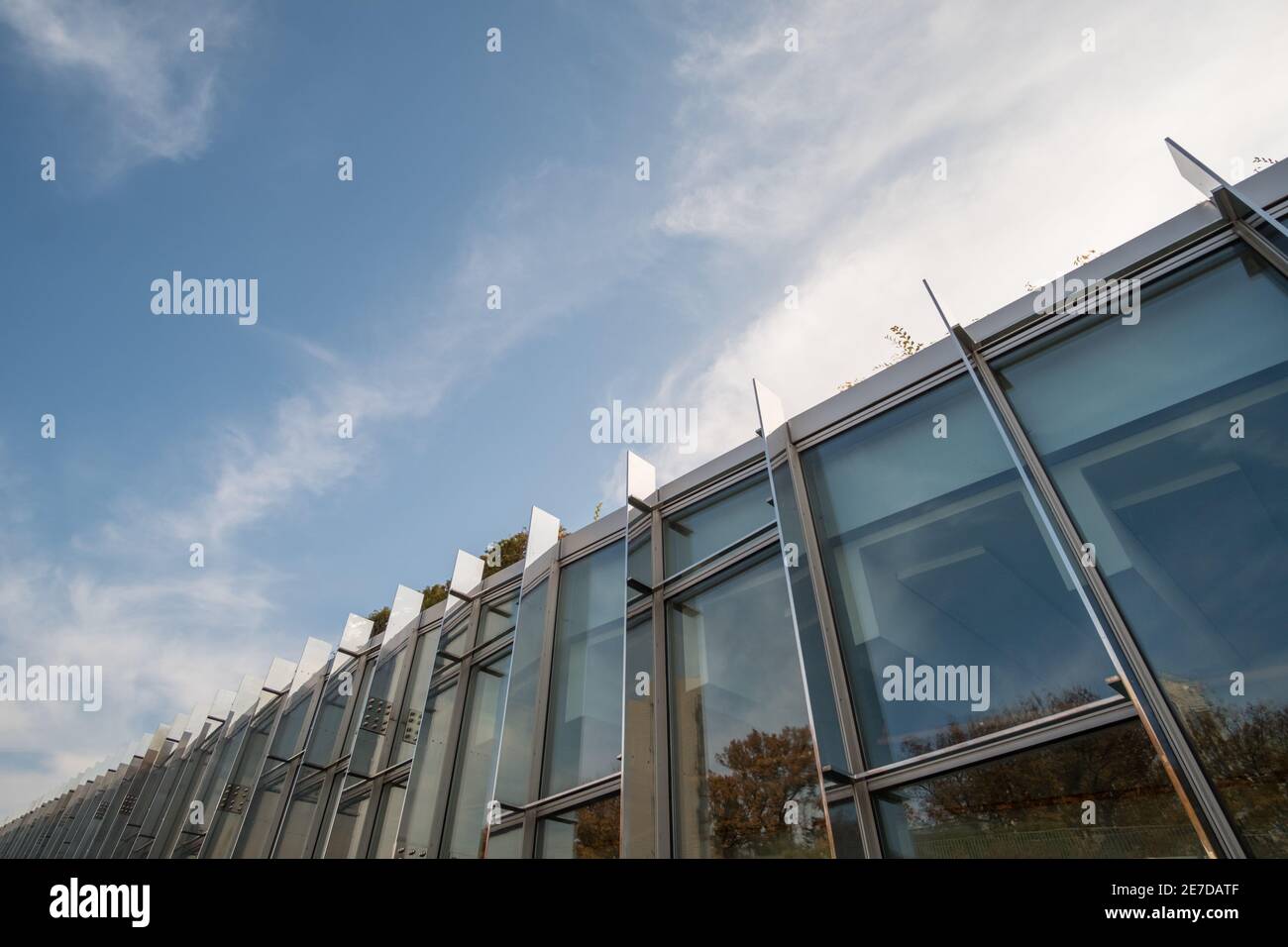 Modern glass facade office building against blue sky Stock Photo - Alamy
