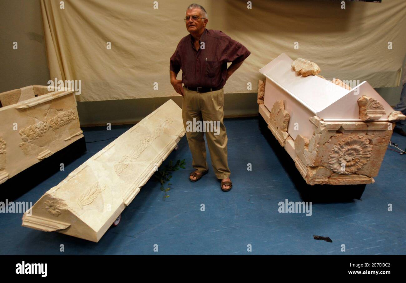 Hebrew University archaeologist Ehud Netzer poses beside sarcophagi, found where Herod's fortress palace once stood, in Jerusalem November 19, 2008. Netzer said on Wednesday he had unearthed the 2,000-year-old remains of two sacrophagi in which a wife and daughter-in-law of the biblical King Herod had been interred. The findings announced by Netzer could cast new light on the lavish lifestyle of the Roman-era monarch also known as the 'King of the Jews.'    REUTERS/Baz Ratner (JERUSALEM) Stock Photo