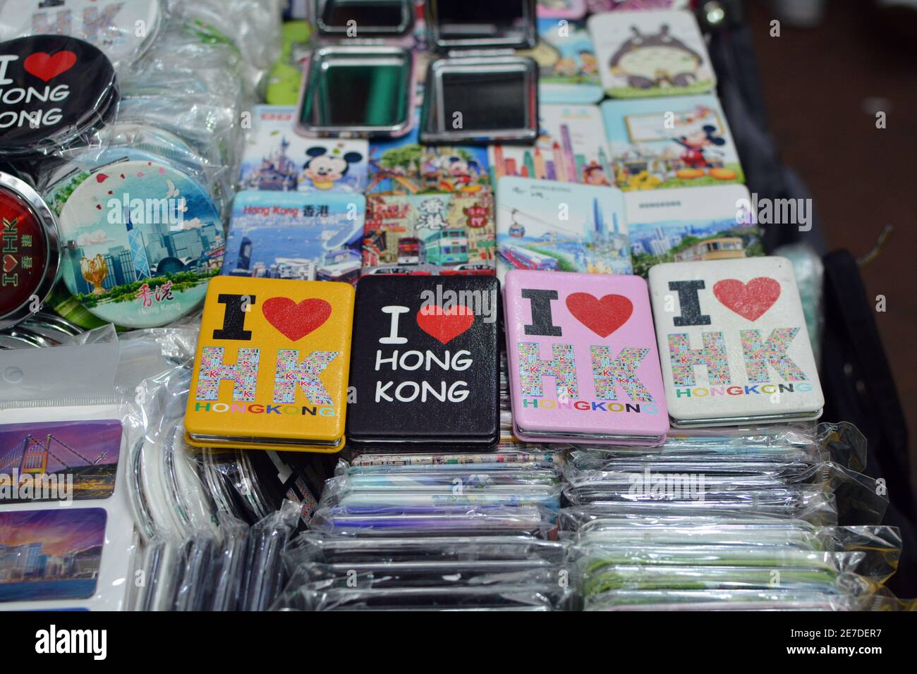 The night market in Temple street Hong Kong, lots of trinkets,tshirts and signs on sale. Cheap and cheerful souvenirs for tourists. Stock Photo