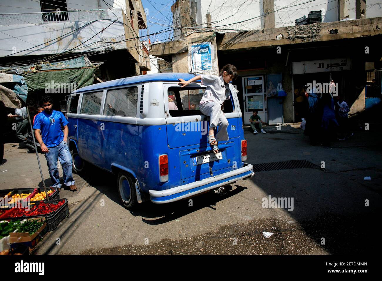 A Palestinian girl jumps out of a van in the Palestinian Beddawi refugee  camp in northern Lebanon May 28, 2007. Palestinian leaders on Monday sought  to end a bloody standoff between the