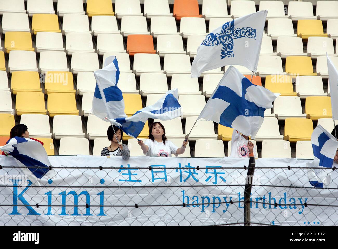 Fans of Ferrari Formula One driver Kimi Raikkonen of Finland hold banners and flags as they congratulate him on his birthday during the second practice session for Sunday's Chinese F1 Grand Prix at the Shanghai Circuit October 17, 2008.   REUTERS/Aly Song (CHINA) Stock Photo