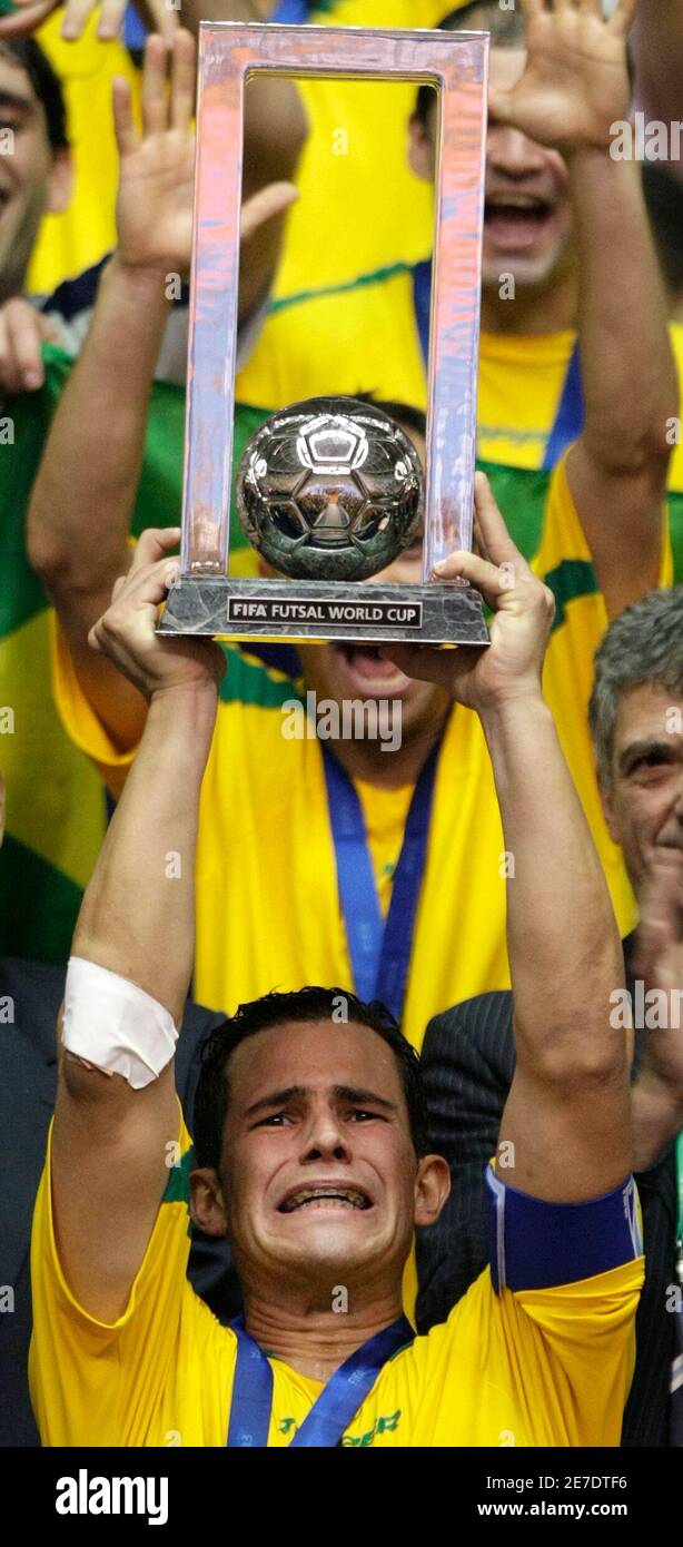Vinicius of Brazil holds a trophy after winning the FIFA Futsal World Cup final soccer match against Spain at the Gimnasio Maracanazinho in Rio de Janeiro October 19, 2008. REUTERS/Sergio Moraes  (BRAZIL) Stock Photo