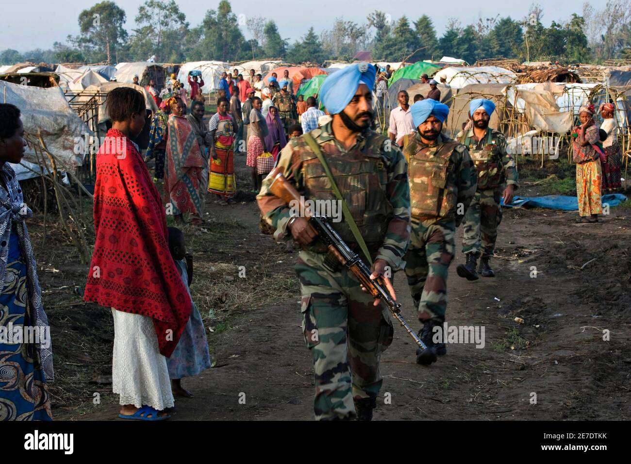 Indian U.N. peacekeepers patrol through a camp for people displaced by fighting in Kiwanja, 70 km (50 miles) north of Goma in eastern Congo, November 22, 2008. REUTERS/Finbarr O'Reilly (DEMOCRATIC REPUBLIC OF CONGO) Stock Photo