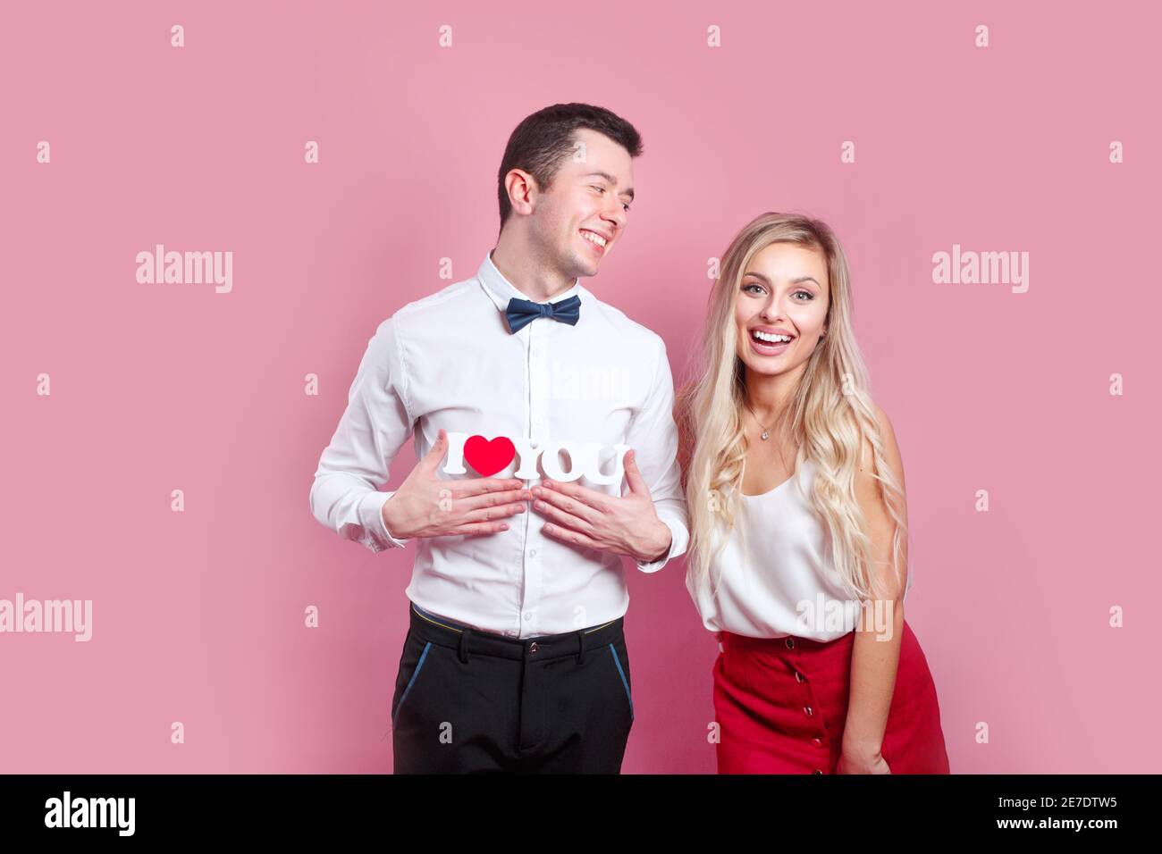 I love you. Happy couple in love on pink background. Happy Valentines day. Stock Photo