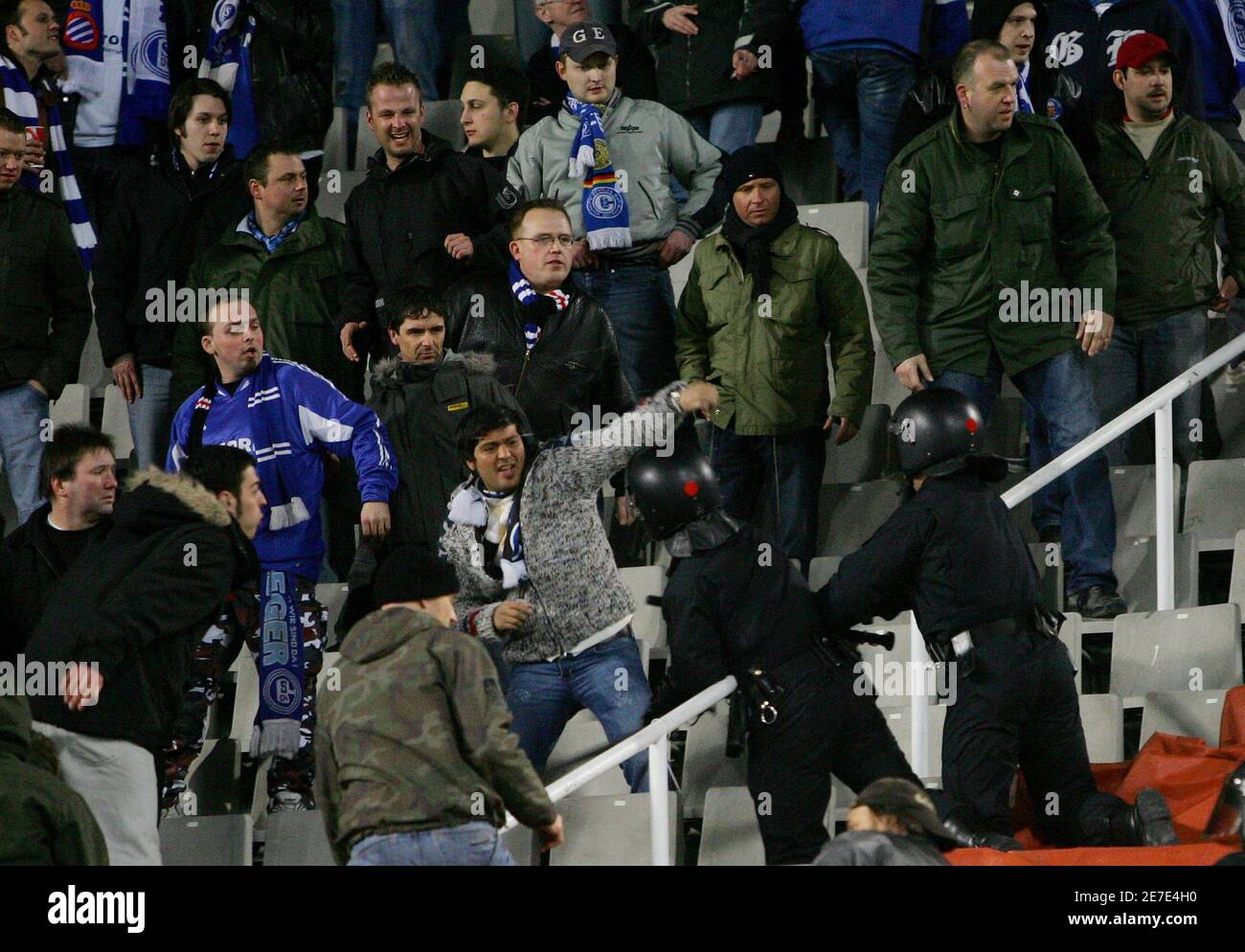 Catalan police repress German supporters of Schalke 04 during their UEFA Cup 3rd round second leg soccer match against Espanyol at Lluis Companys stadium in Barcelona, Spain, February 23, 2006. REUTERS/Gustau Nacarino Stock Photo