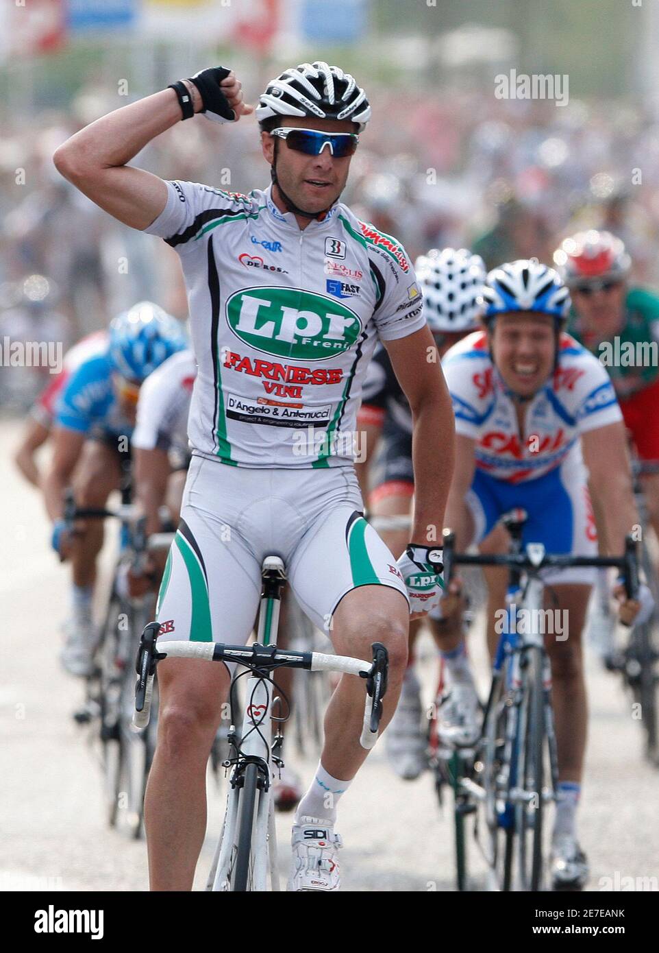 Alessandro Petacchi of Italy his arm as he crosses the finishing line of the 97th Scheldeprijs/Grand Prix de l'Escaut cycling race in Schoten April 15, 2009. Kenny Van Hummel (R) of
