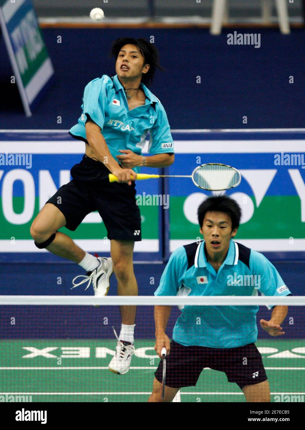 Japan S Shoji Sato Returns A Shot In Front Of Teammate Naoki Kawamae R During Their Men S Doubles Match Against Malaysia S Chan Chong Ming And Chew Choon Eng In A Preliminary Round Of
