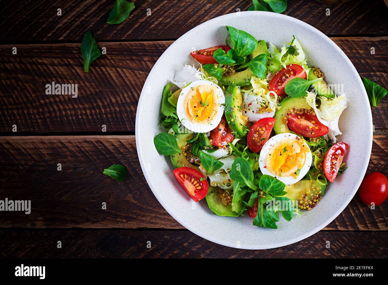 Fresh avocado salad with tomato, avocado, boiled eggs and fresh lettuce