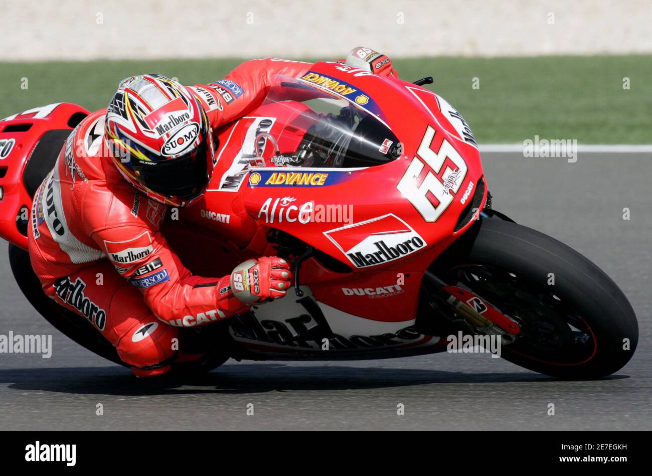 Ducati MotoGP rider Loris Capirossi of Italy takes a corner during a  morning qualifying practice session before the Qatar Grand Prix at Losail  International Circuit in Qatar September 29, 2005. REUTERS/Fadi Al-Assaad