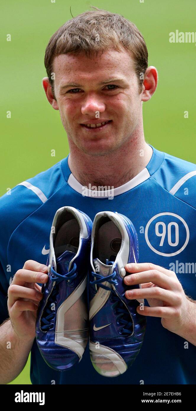 England and Manchester United striker Wayne Rooney poses for photographs  with his new World Cup football boots at Old Trafford in Manchester,  northern England, April 25, 2006. The boots, called the Total