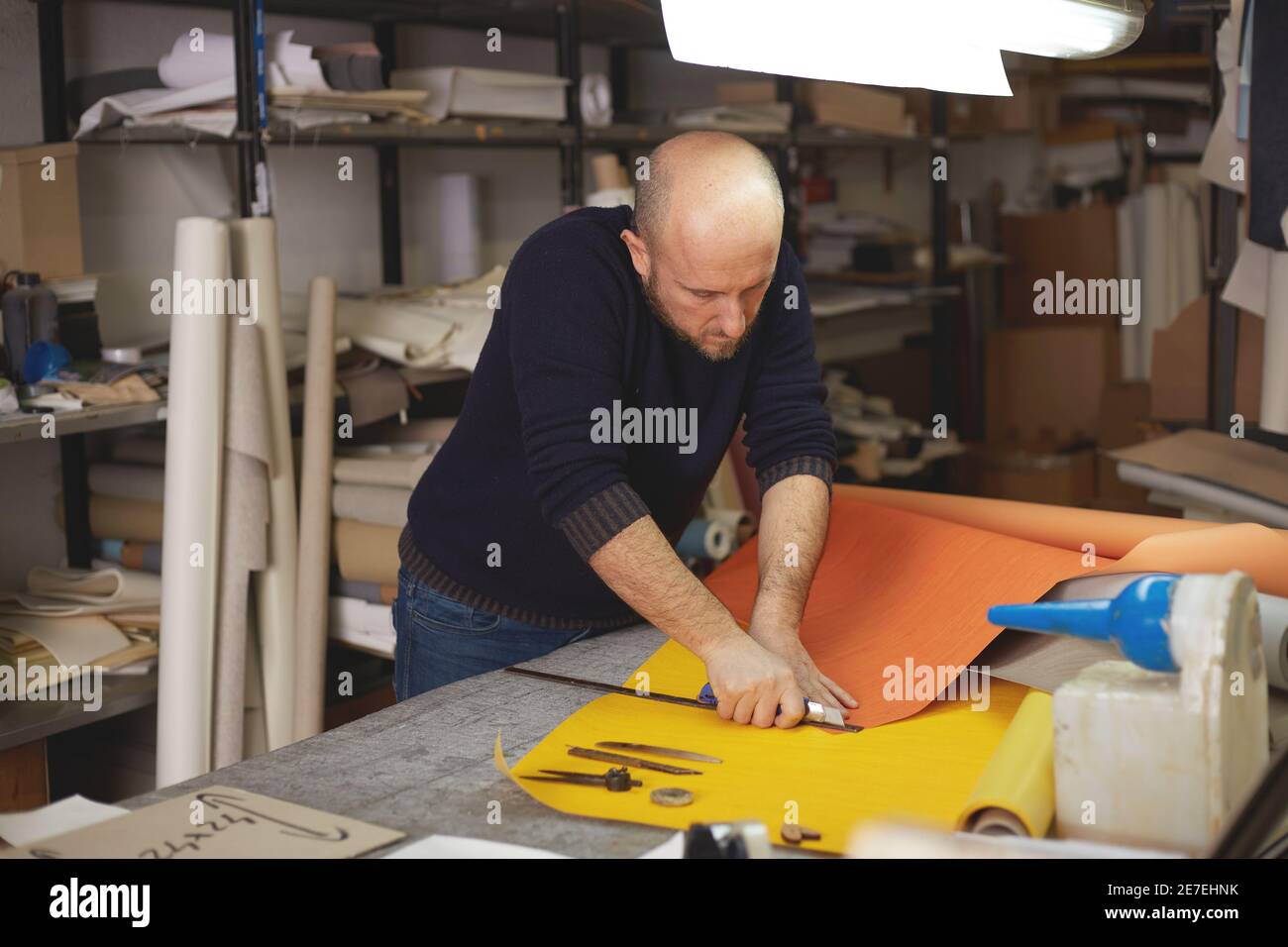 craftsman cutting leather with cutter in Stock Photo Alamy