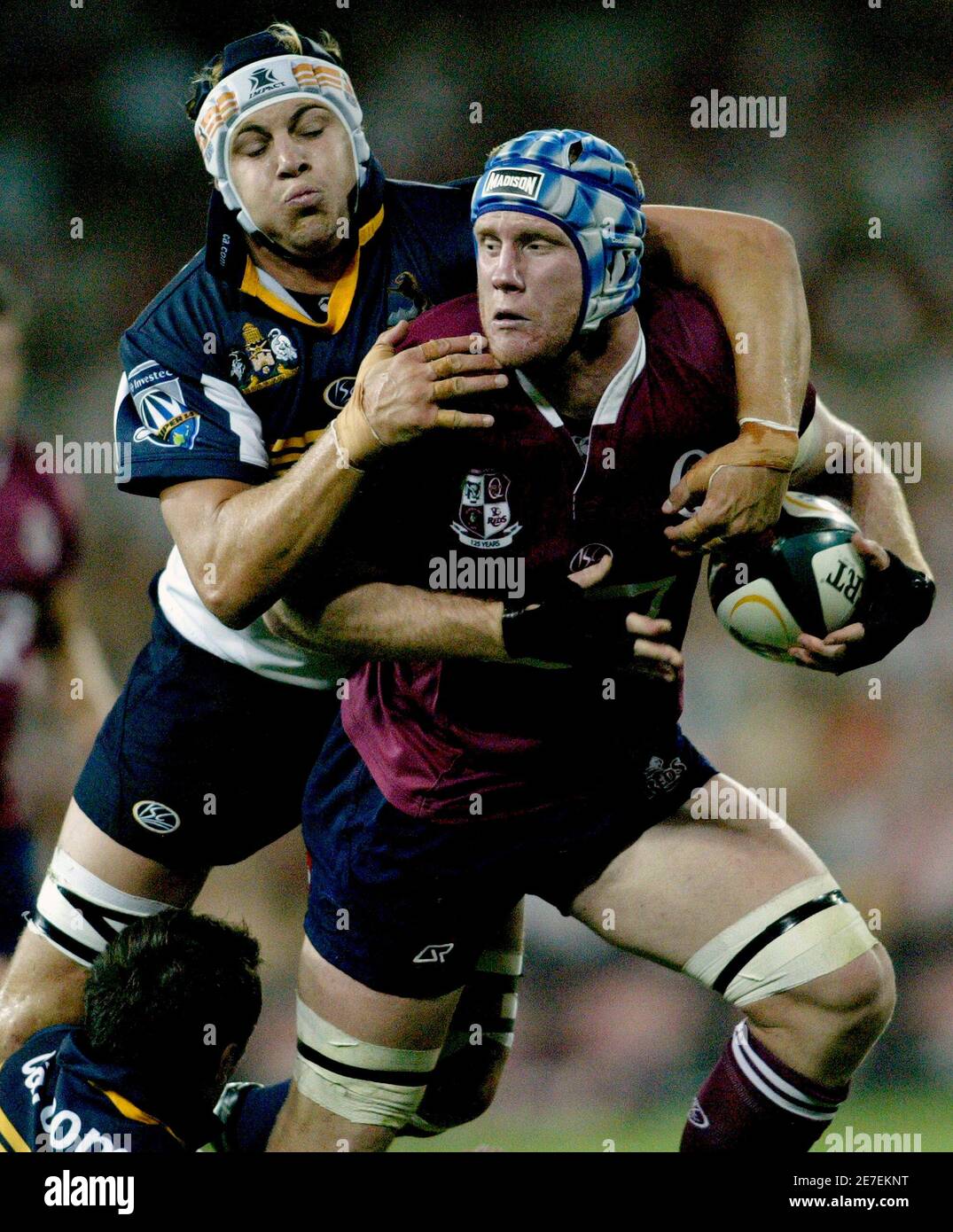 Reds captain John Roe is tackled by Brumbies' Stephen Hioles during their  Super 14 rugby union match in Brisbane February 17, 2007. REUTERS/Greg  White (AUSTRALIA Stock Photo - Alamy