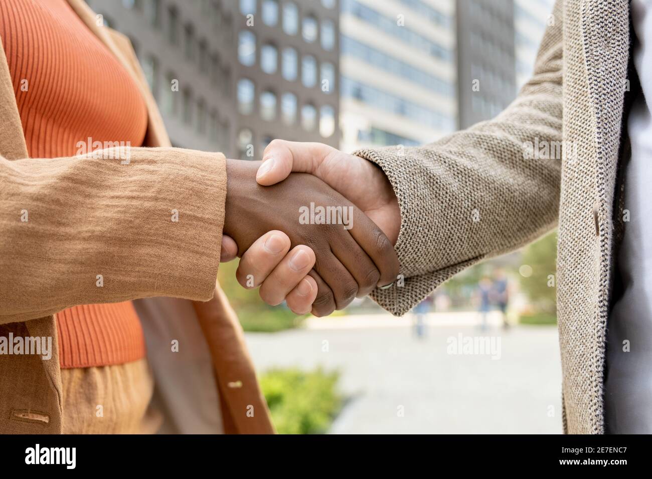 Close-up of business people shaking hands they greeting each other outdoors Stock Photo