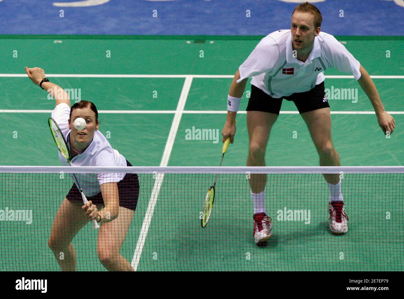 Kamilla Rytter Juhl of Denmark (L) reaches for a shot in front of her  teammate Thomas Laybourn during their mixed doubles quarter-final badminton  match against Flandy Limpele and Vita Marissa of Indonesia