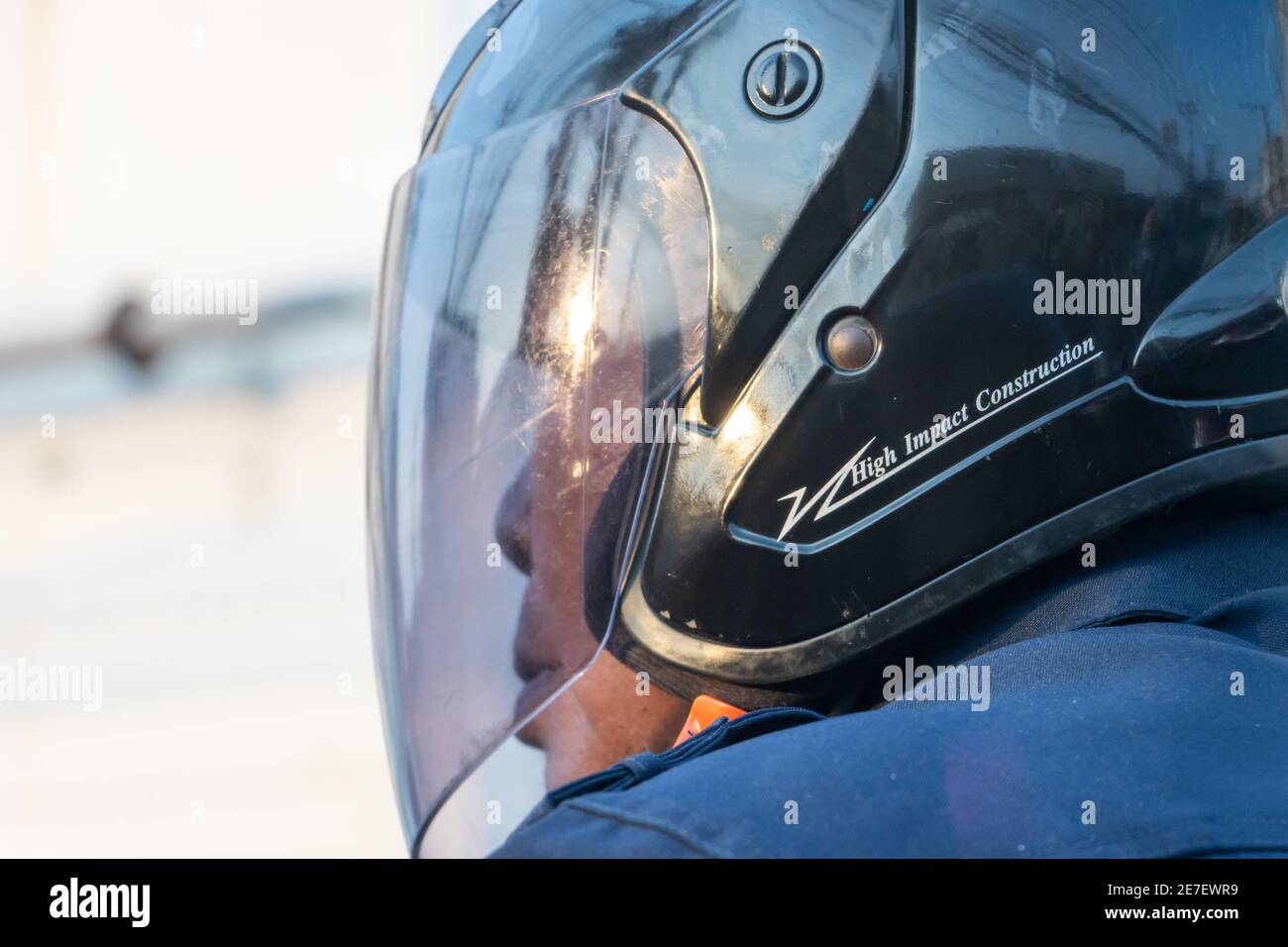 SAMUT PRAKAN, THAILAND, MAR 14 2020, The portrait of a man in a helmet riding a motorcycle. Stock Photo