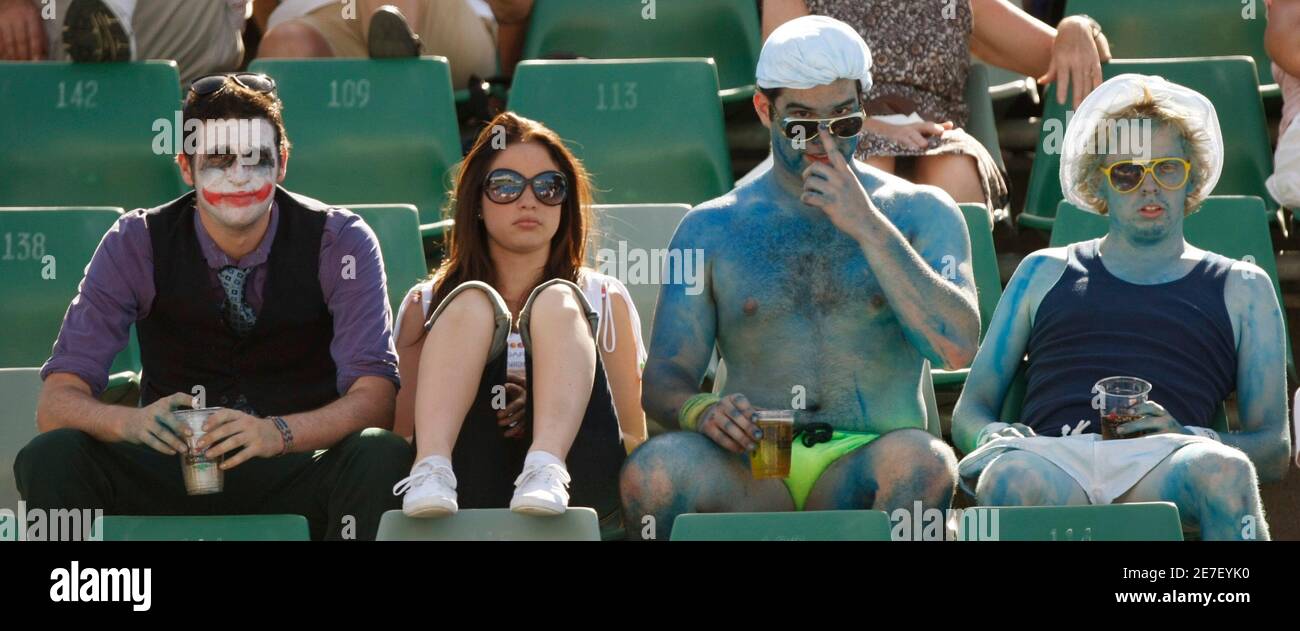 A fan in fancy dress, as the Joker from the film 'Batman The Dark Knight', watches the match between Spain's Virginia Ruano Pascual and Denmark's Caroline Wozniacki at the Australian Open tennis tournament in Melbourne January 21, 2009. REUTERS/Mick Tsikas (AUSTRALIA) Stock Photo