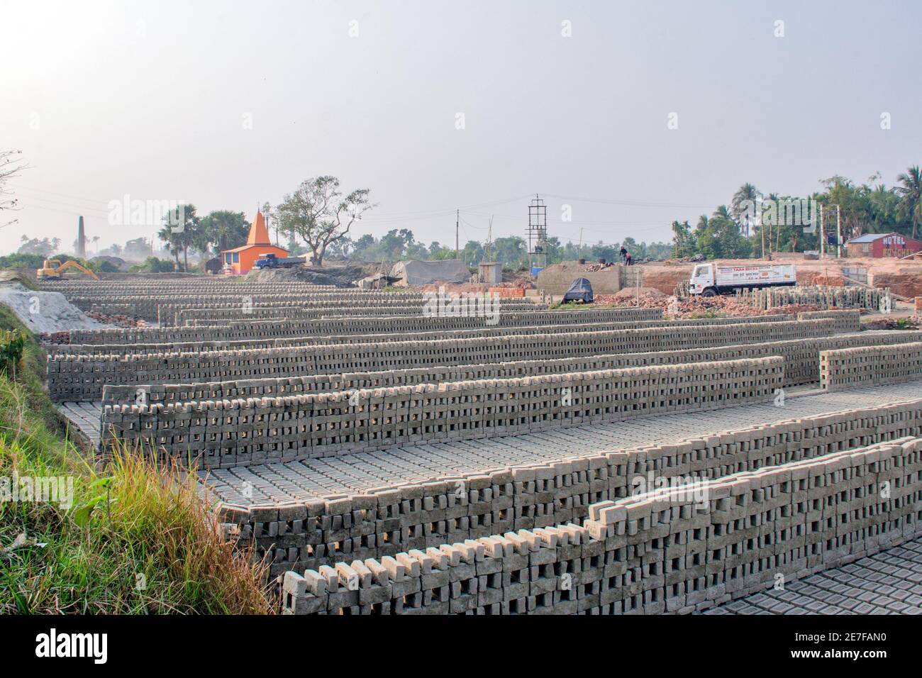 Pictures of brick kilns in rural Bengal where work is in full swing. A stockpile of raw bricks and finished bricks throughout the brick kiln. Stock Photo