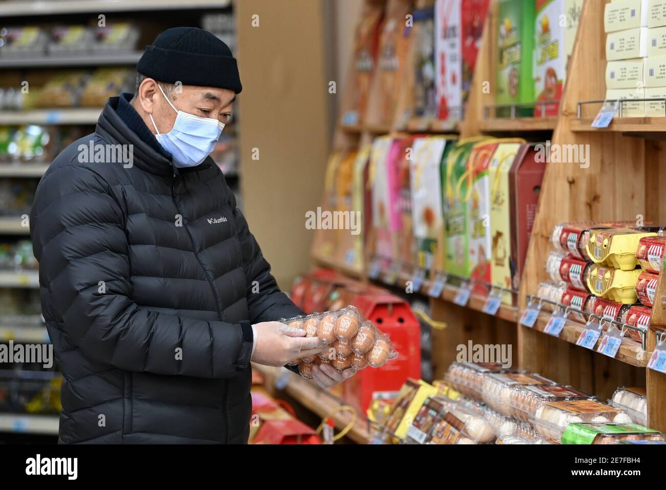 Harbin, China's Heilongjiang Province. 30th Jan, 2021. A resident selects eggs at a supermarket in Xiangfang District of Harbin, northeast China's Heilongjiang Province, Jan. 30, 2021. Price and supply of daily necessities are stable in Harbin amid the ongoing COVID-19 pandemic, local authorities told a press briefing here on Saturday. Credit: Wang Jianwei/Xinhua/Alamy Live News Stock Photo