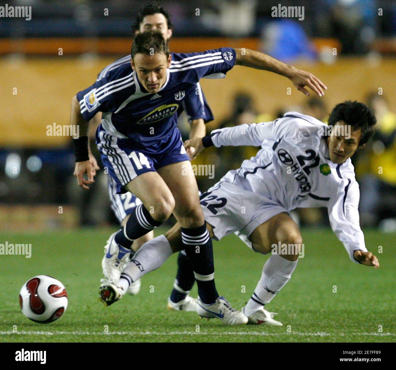 Auckland City FC forward Keryn (14) South Africa battles the ball against Chonbuk Motors midfielder Kim Hyeung-bum (22) of South Korea during the fifth-place play-off match of the FIFA