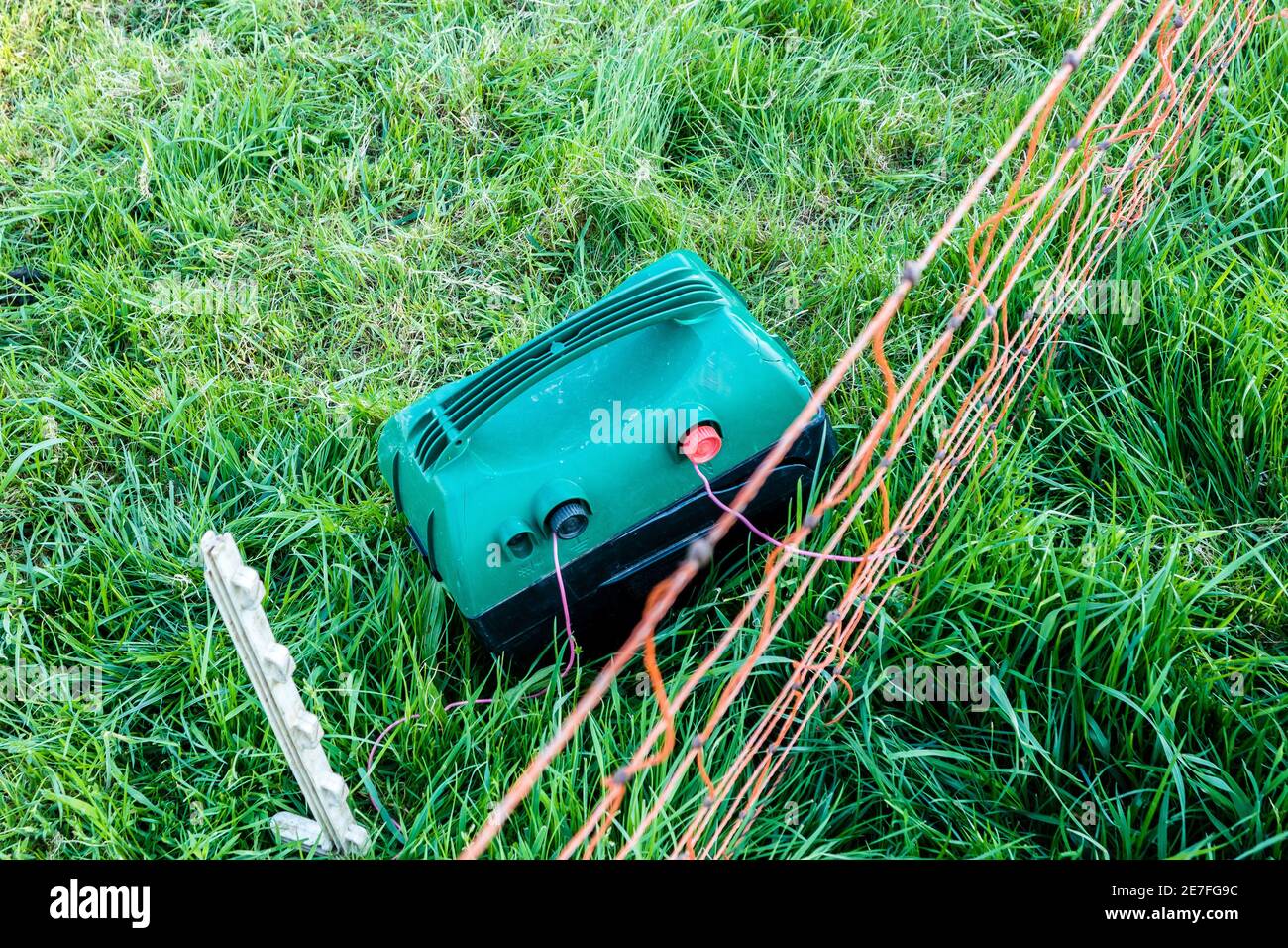 Electric fencing with a battery displayed on a meadow Stock Photo Alamy