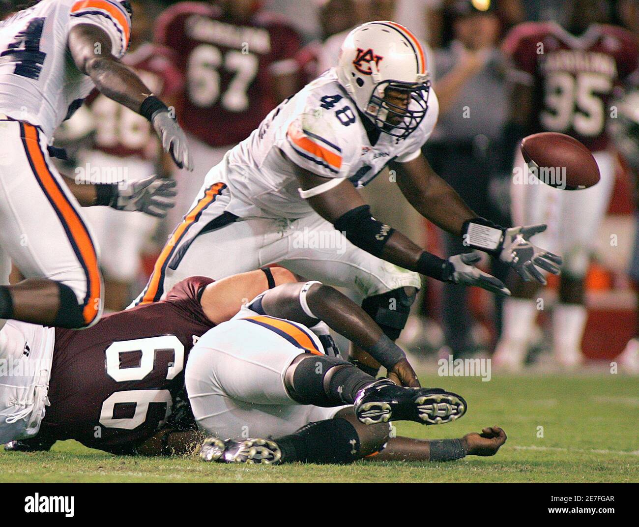 Auburn University defensive end Marquies Gunn (48) recovers a fumble by  University of South Carolina wide receiver Syvelle Newton (not shown),  before fumbling the ball himself that was recovered by South Carolina,