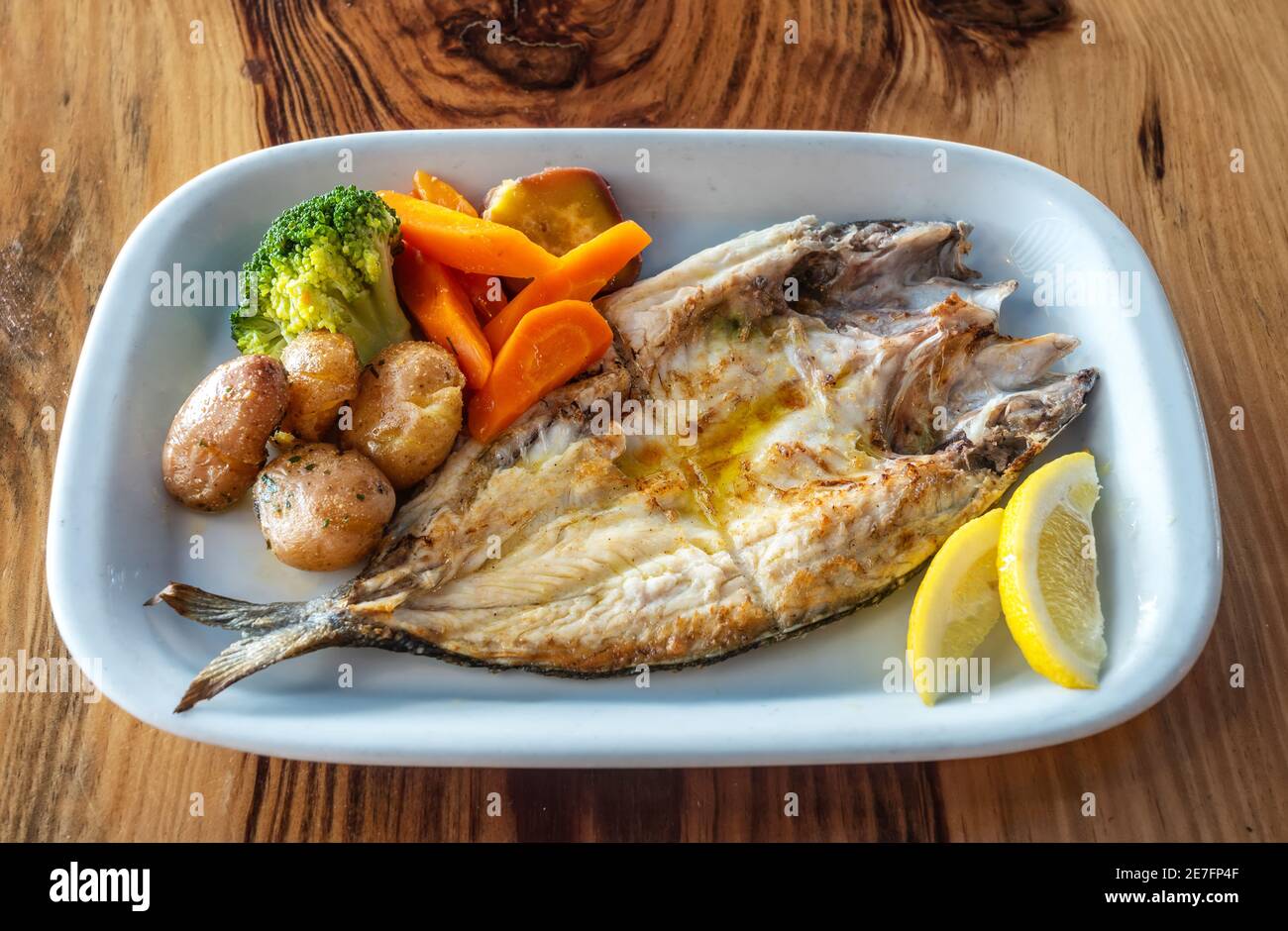 Grilled fish plate with some nicely roasted potatoes, carrots and