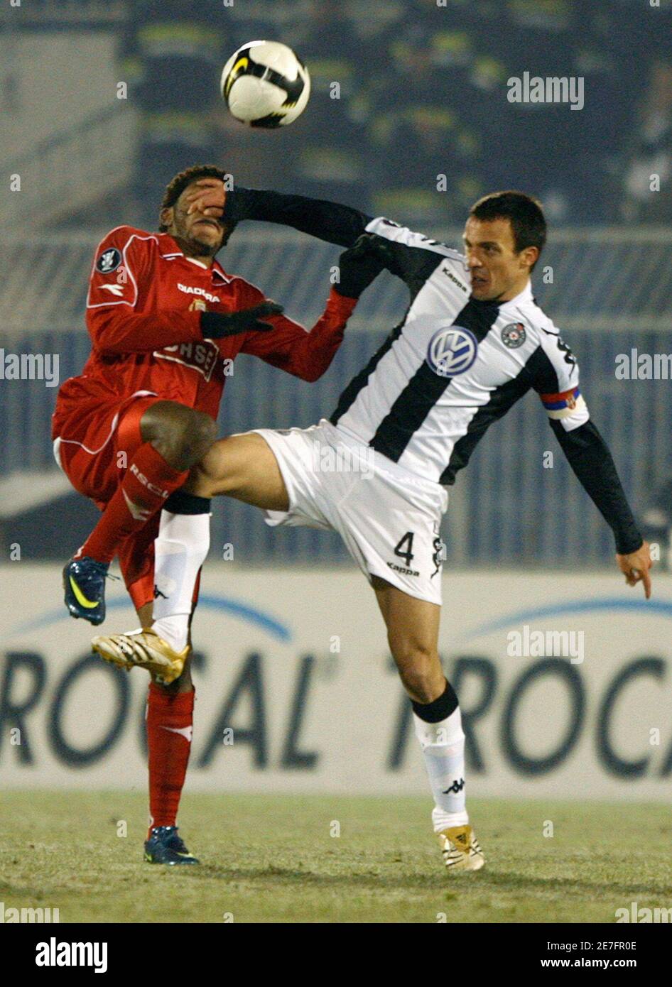 Standard Liege's Igor De Camargo (L) is challenged by Partizan Belgrade's  Nenad Djordjevic for the ball during their UEFA Cup soccer match in  Belgrade November 27, 2008. REUTERS/Marko Djurica (SERBIA Stock Photo -