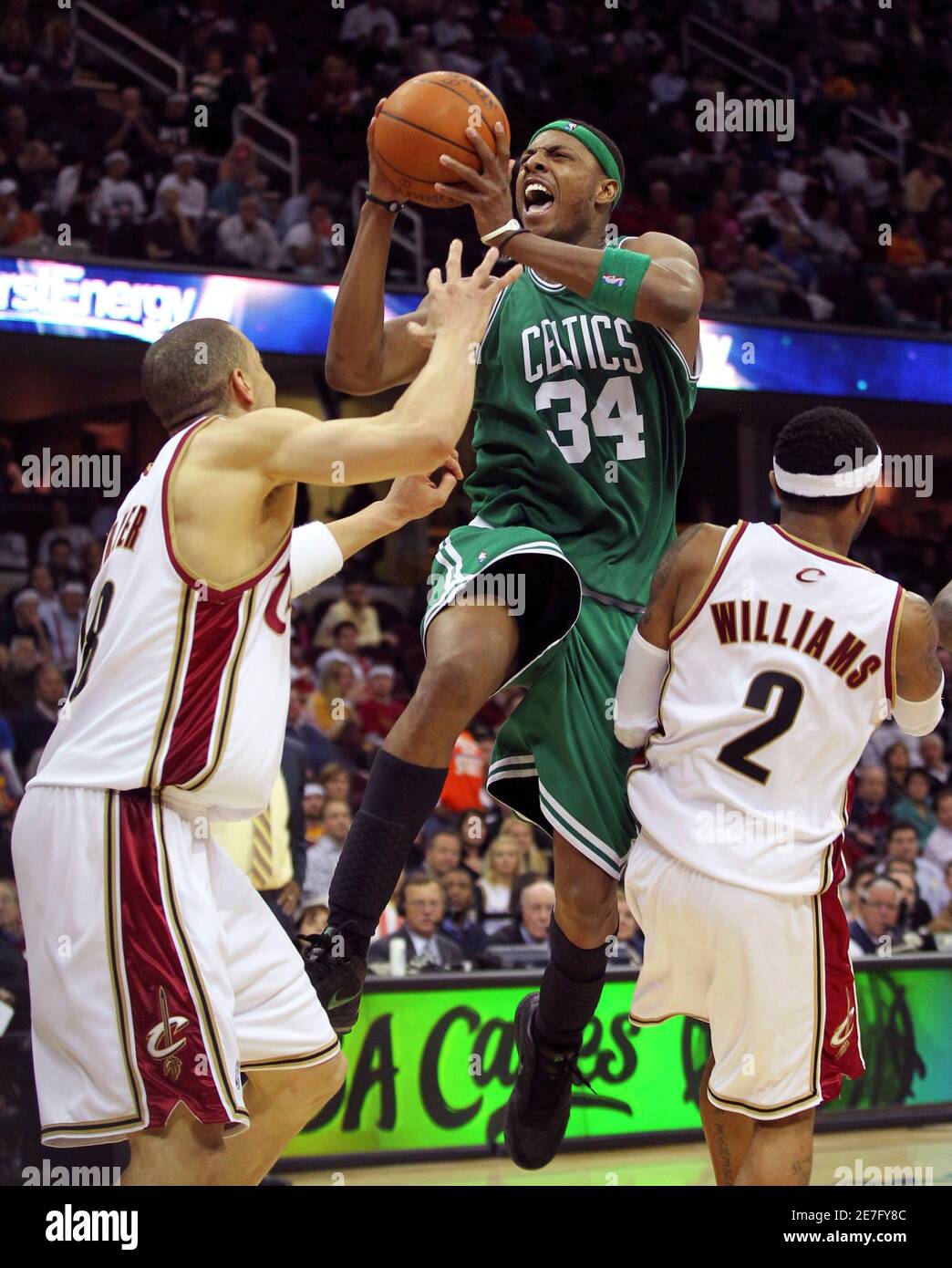 Boston Celtics' Paul Pierce (C) drives to the net between Cleveland Cavaliers' Anthony Parker and Mo Williams (R) during the fourth quarter in Game 5 of their NBA Eastern Conference playoff basketball series in Cleveland, May 11, 2010. REUTERS/Aaron Josefczyk (UNITED STATES - Tags: SPORT BASKETBALL) Stock Photo