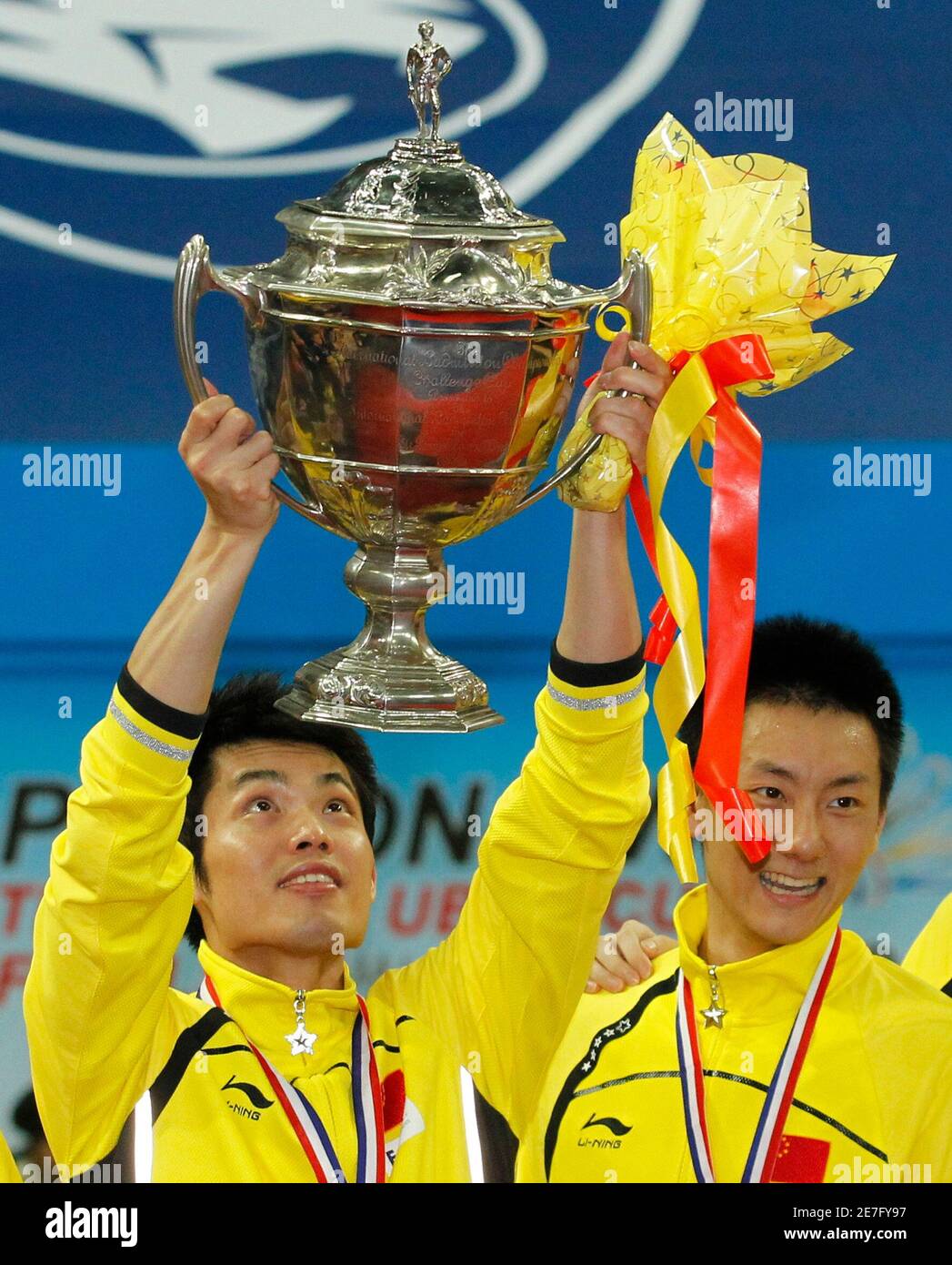 China's Lin Dan (L) holds up the Thomas Cup trophy next to team mate Chen  Jin after China won against Indonesia in the final round of the Thomas Cup  badminton championship in