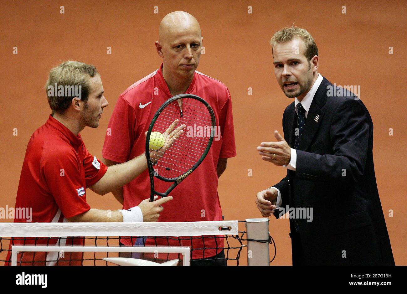 Olivier Rochus (L) of Belgium and his coach Steven Martens (C) talk to  umpire Sune Alenkaer during a Davis Cup World Group Play-offs tennis match  between Rochus and Andy Roddick of the