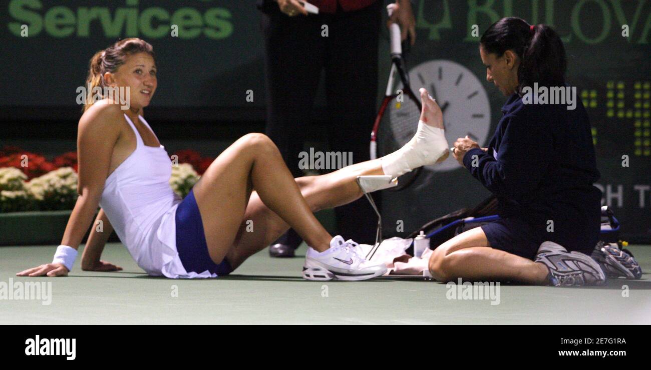 Tatiana Golovin of France has her ankle tended to by medical staff after an  injury in the third set of her semi final against Maria Sharapova of Russia  at the Nasdaq-100 Open