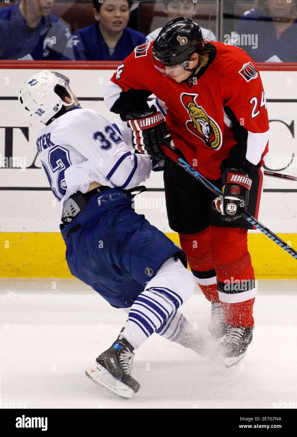 Ottawa Senators' Anton Volchenkov (R) hits Toronto Maple Leafs' Alex Foster during the first period of their NHL hockey game in Ottawa March 22, 2008.       REUTERS/Chris Wattie       (CANADA) Stock Photo