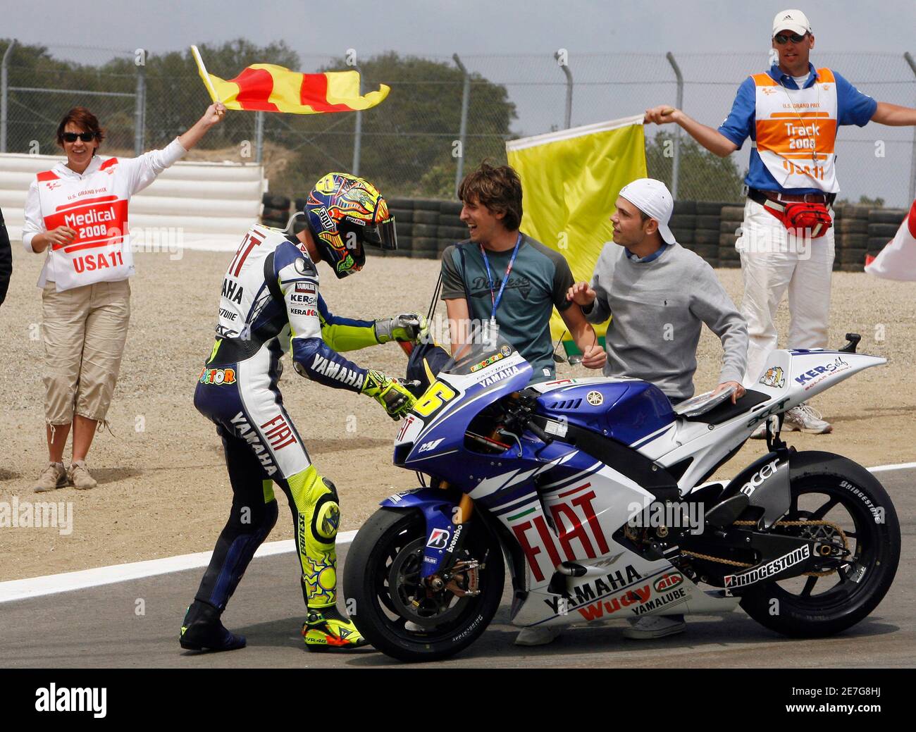Yamaha MotoGP rider Valentino Rossi of Italy (2nd L) celebrates on the  track after winning the 2008 U.S. Grand Prix at Laguna Seca raceway near  Monterey, California July 20, 2008. Rossi went