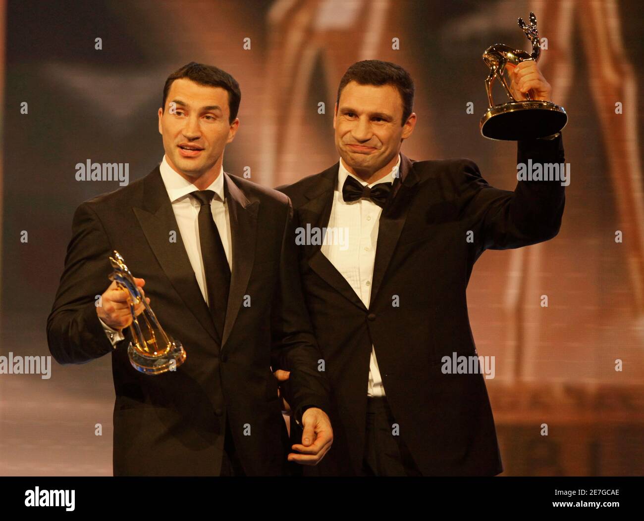 Boxers Wladimir (L) and Vitali Klitschko of Ukraine hold up their Bambi Sportliche Leistung (sporting achievement) awards during the 61st Bambi media awards ceremony in Potsdam November 26, 2009. Each year, German media company 'Hubert Burda Media', honours celebrities from the world of entertainment, literature, sports and politics with the Bambi awards. REUTERS/Tobias Schwarz (GERMANY) Stock Photo
