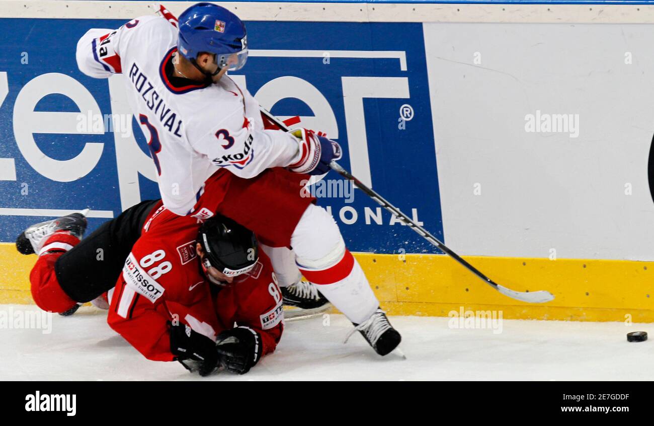 Czech Michal Rozsival challenges Kevin Romy of Switzerland during the Ice  Hockey World Championships match in Mannheim, May 15, 2010. REUTERS/Petr  Josek(GERMANY - Tags: SPORT ICE HOCKEY Stock Photo - Alamy