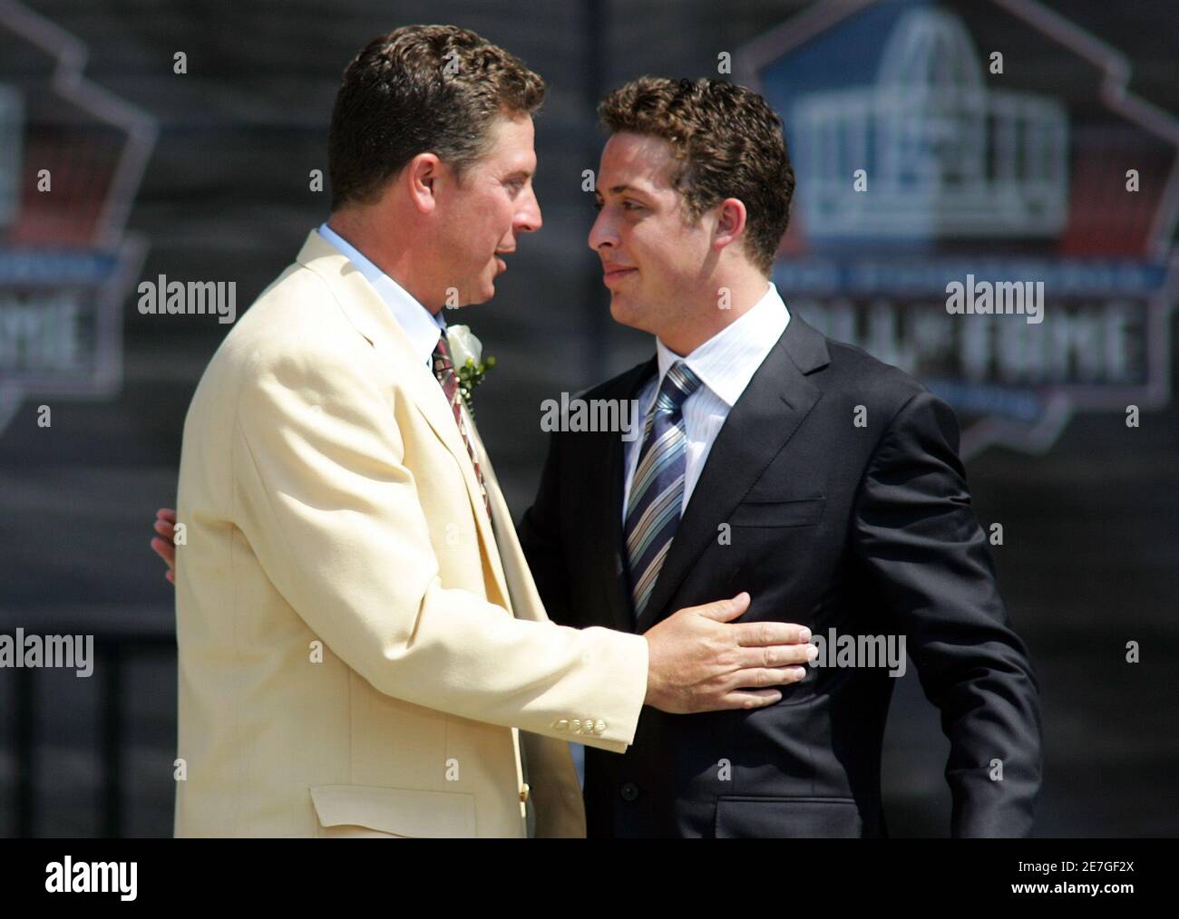 miami-dolphins-former-quarterback-dan-marino-l-hugs-his-son-at-his-induction-into-the-pro-football-hall-of-fame-in-canton-ohio-august-7-2005-marino-was-inducted-along-with-steve-young-fritz-pollard-and-benny-friedman-reutersmarc-serota-msmk-2E7GF2X.jpg