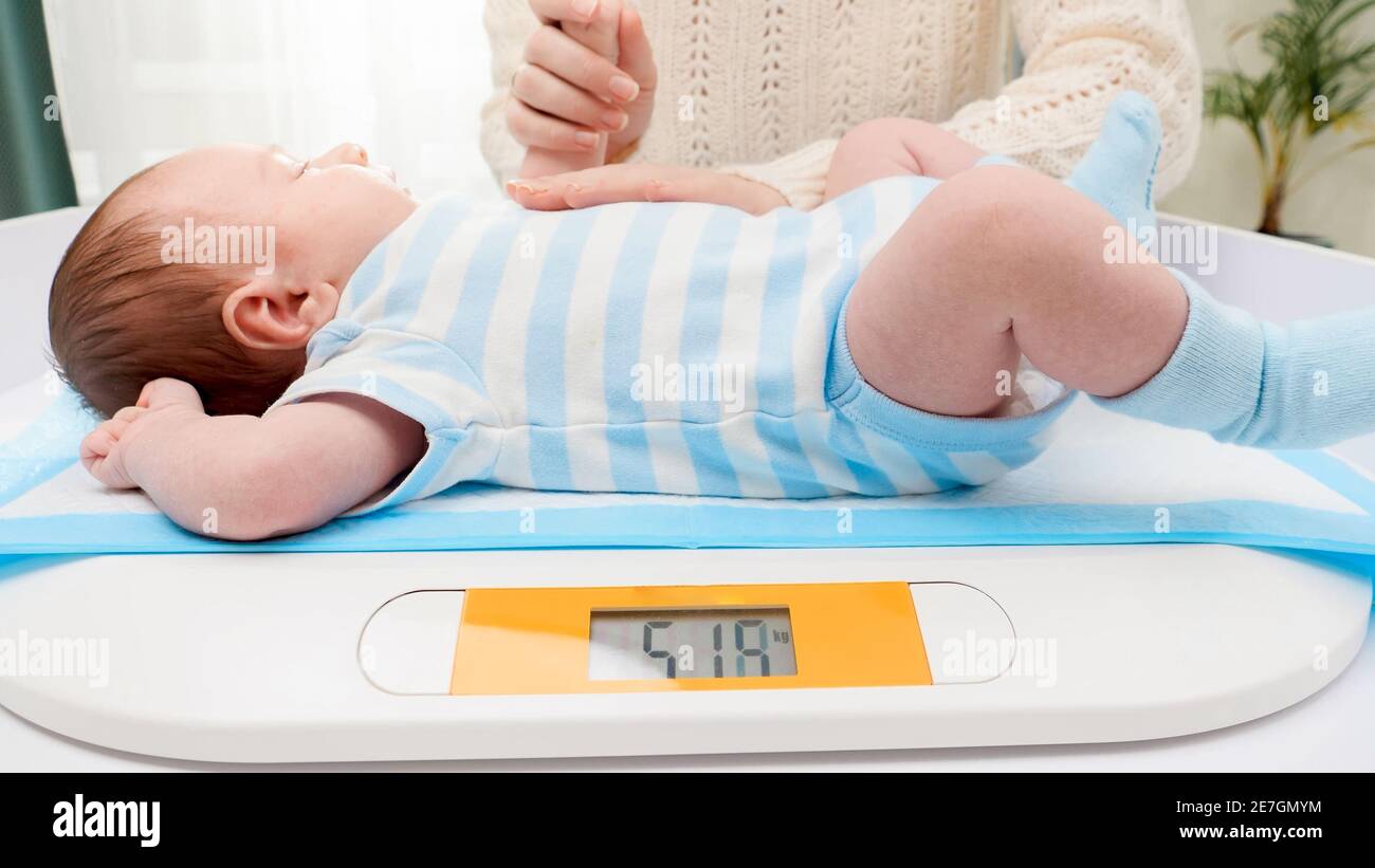 Newborn Baby On Scale. Physical Development Concept Photo Of Child Health  Care. Copy Space Stock Photo, Picture and Royalty Free Image. Image  45816478.