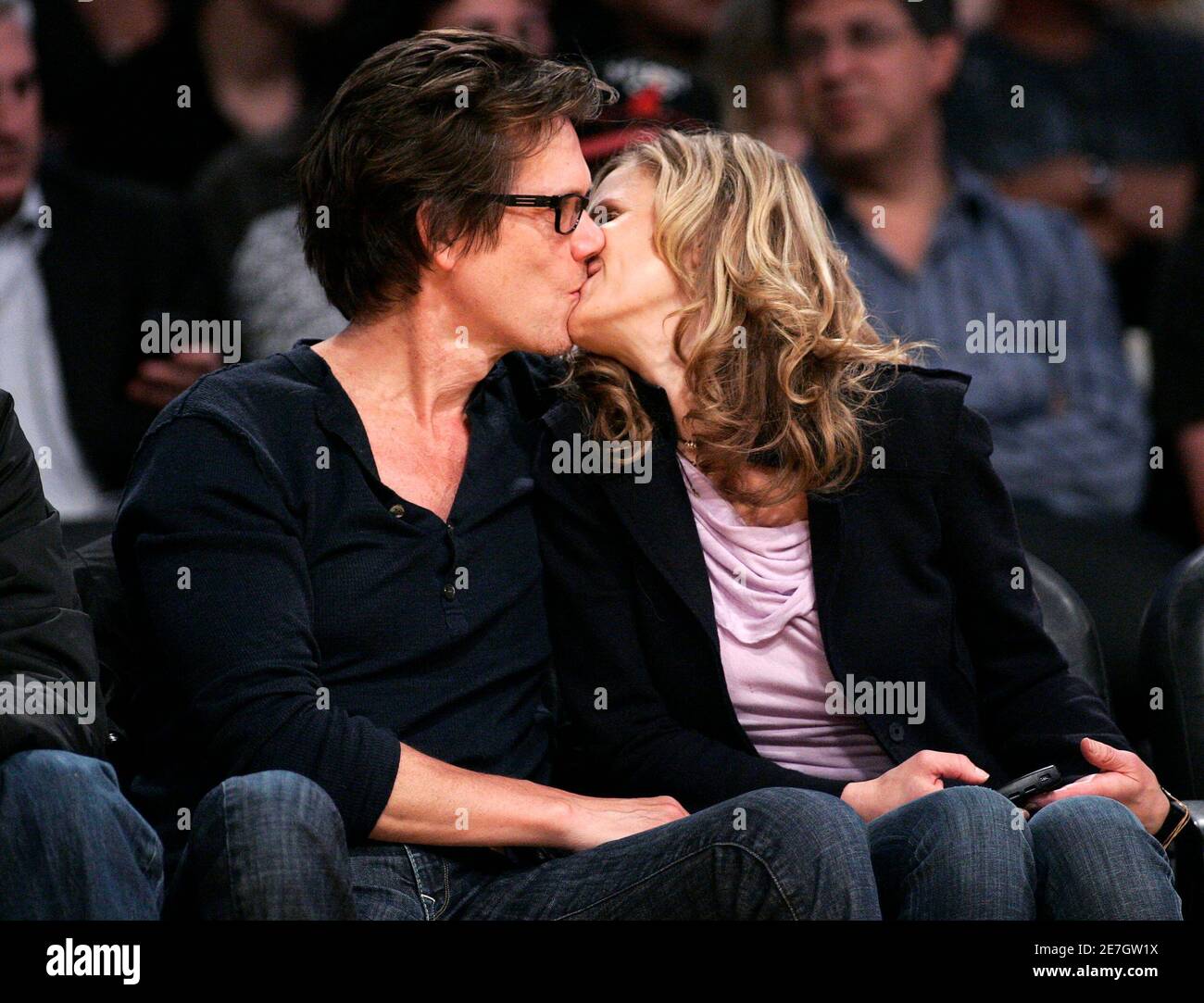 Actors Kevin Bacon (L) kisses his wife Kyra Sedgwick (R) during Game 5 of  their NBA Western Conference semi-final basketball playoff game between the  Los Angeles Lakers and the Houston Rockets in