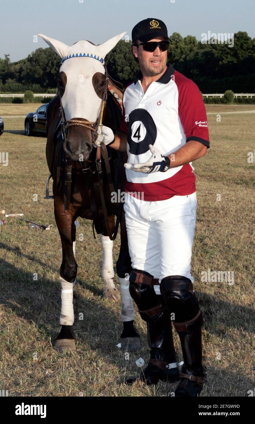 Former Argentine soccer player Gabriel Batistuta leads his horse before  playing polo in an event by Italian fashion house Cavalleria Toscana during  the Pitti Uomo men's fashion week in Florence June 18,