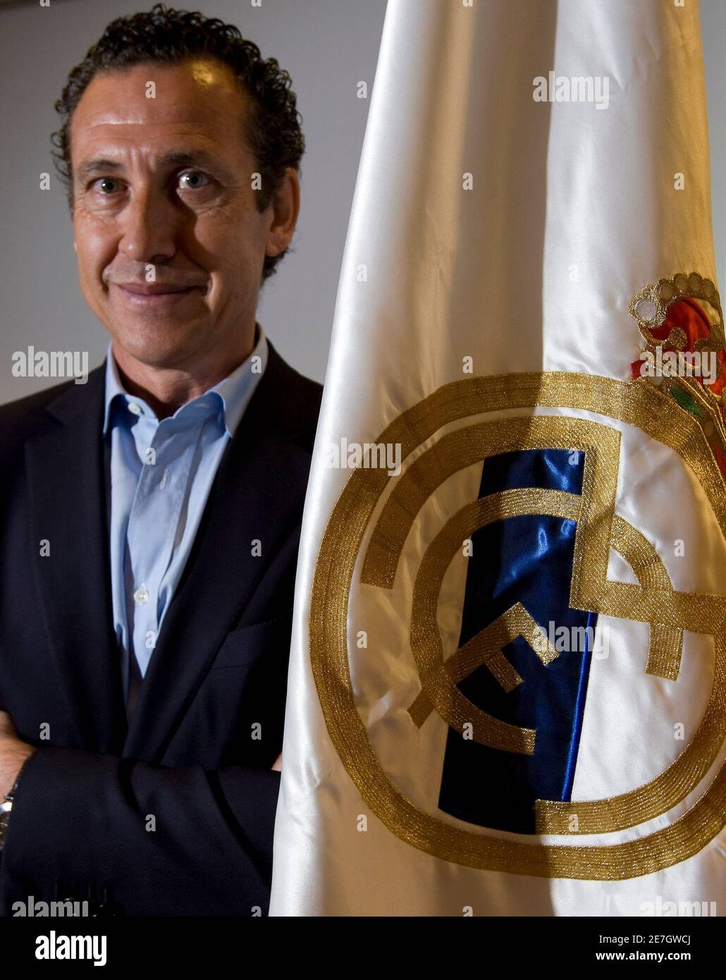 Real Madrid's director general Jorge Valdano poses next to a Real Madrid  flag following an interview with Reuters in Madrid July 13, 2009. Real  Madrid are focusing on selling at least five