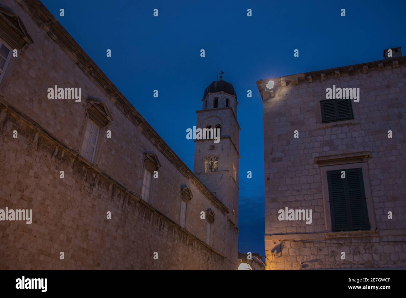Low angle shot of old buildings with a tower on a cloudy sky background ...