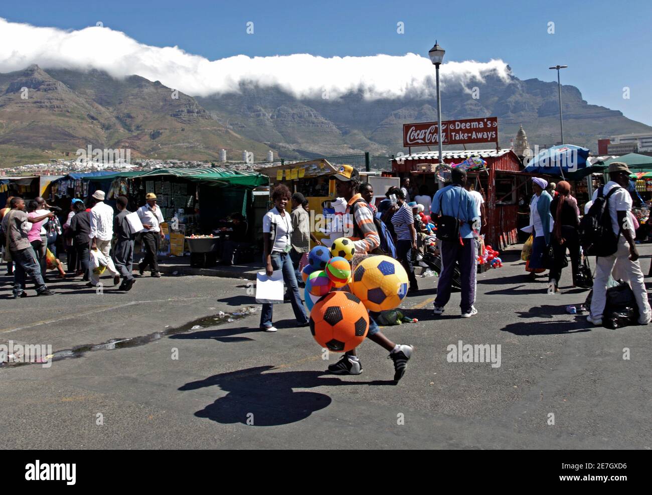 A hawker sells soccer balls ahead of the final draw for the 2010 FIFA
