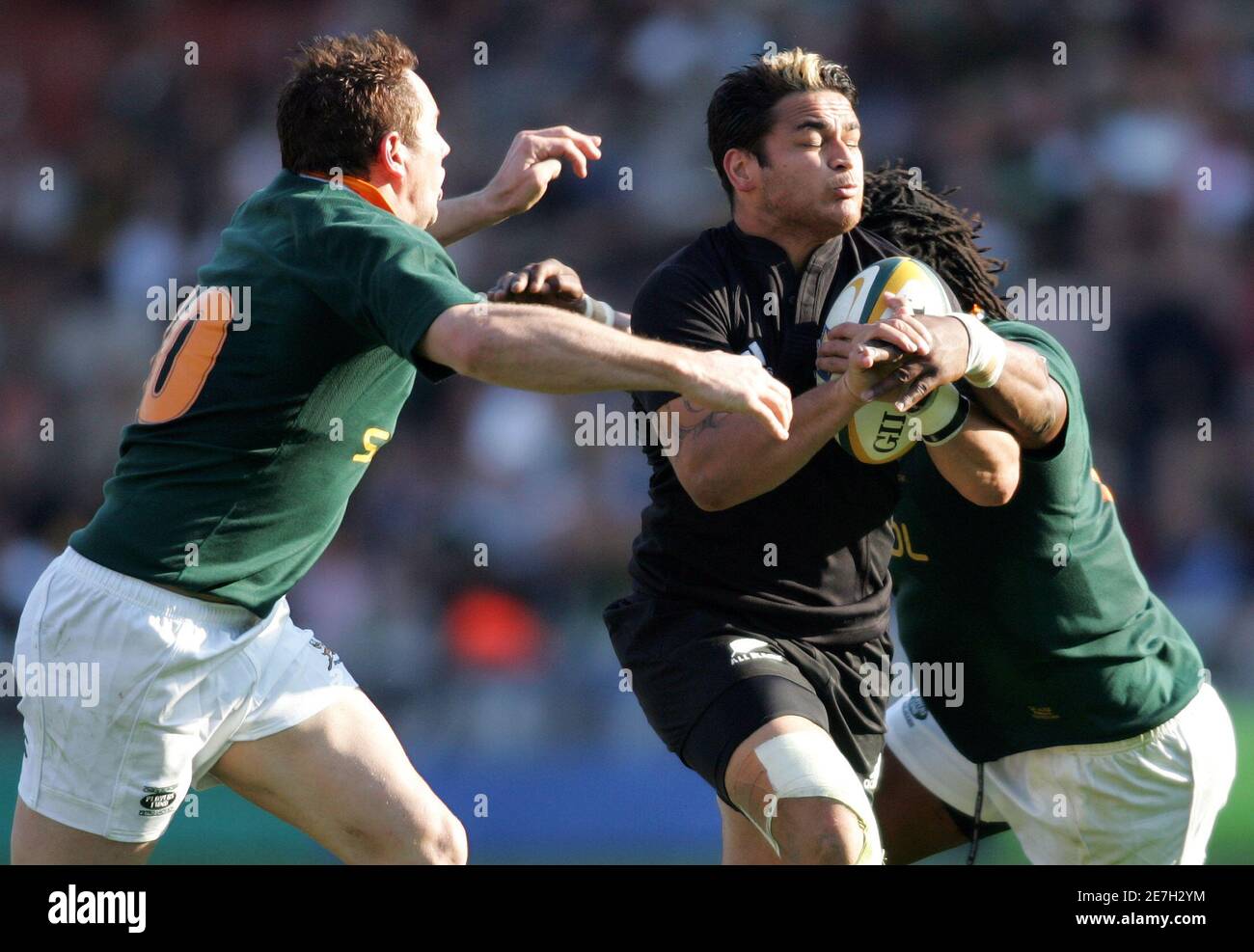 New Zealand's Piri Weepu (C) is tackled by South Africa's Butch Jame (L) and Solly Tyibilika during their Tri-Nations rugby union match in Pretoria, South Africa  August 26, 2006.  REUTERS/Howard Burditt (SOUTH AFRICA) Stock Photo