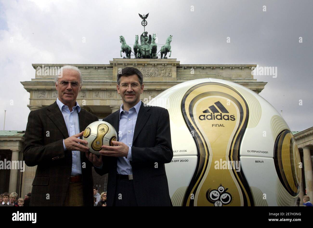 Franz Beckenbauer, President of Germany's World Cup organising committee,  and Adidas CEO Herbert Hainer (R) hold a golden soccer ball during a  presentation next to the Brandenburg gate in Berlin April 18,