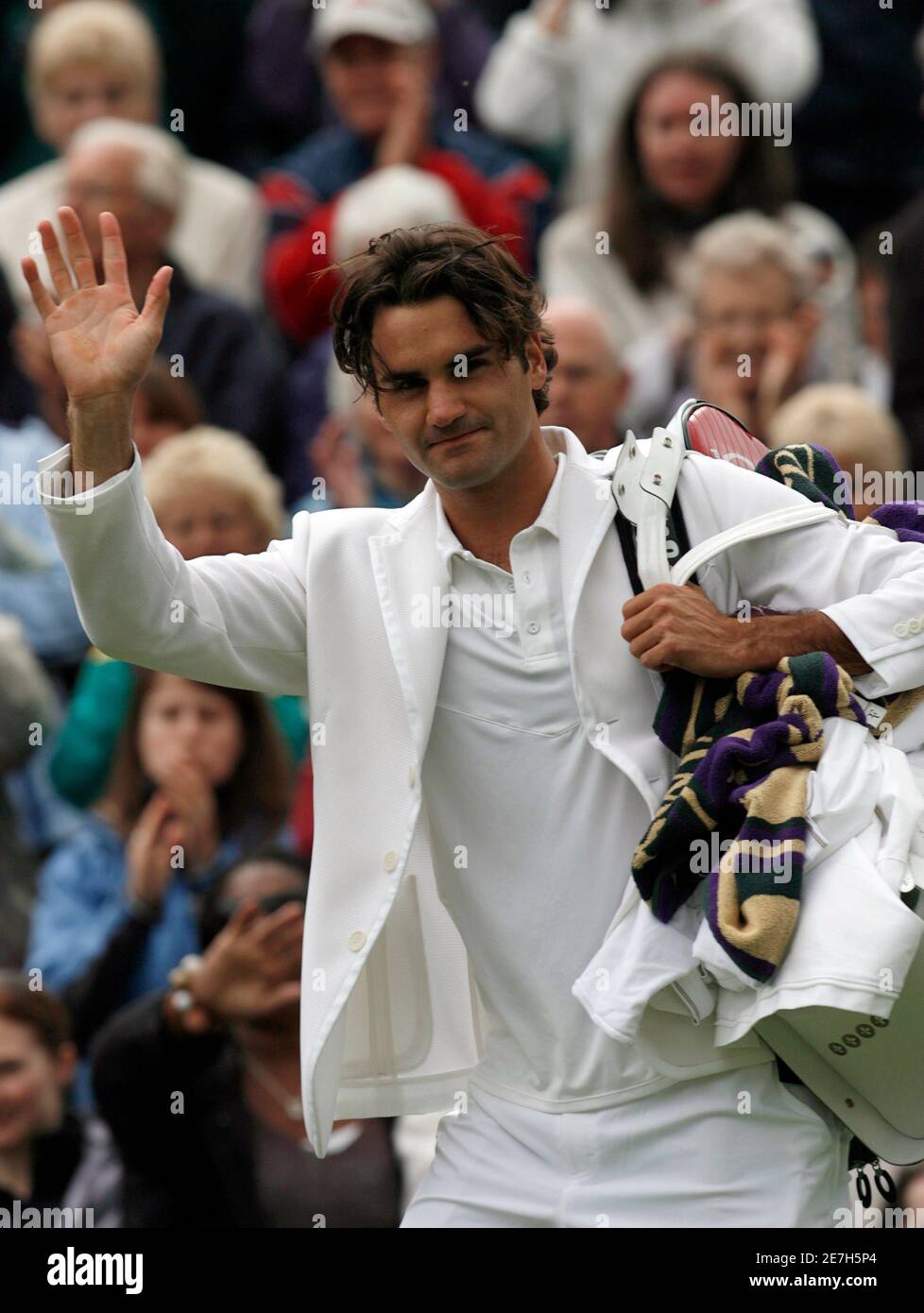Defending champion Roger Federer of Switzerland waves to the crowd as he walks off centre court  after beating Teimuraz Gabashvili of Russia at the Wimbledon tennis championships in London June 25, 2007.     REUTERS/Eddie Keogh (BRITAIN) Stock Photo