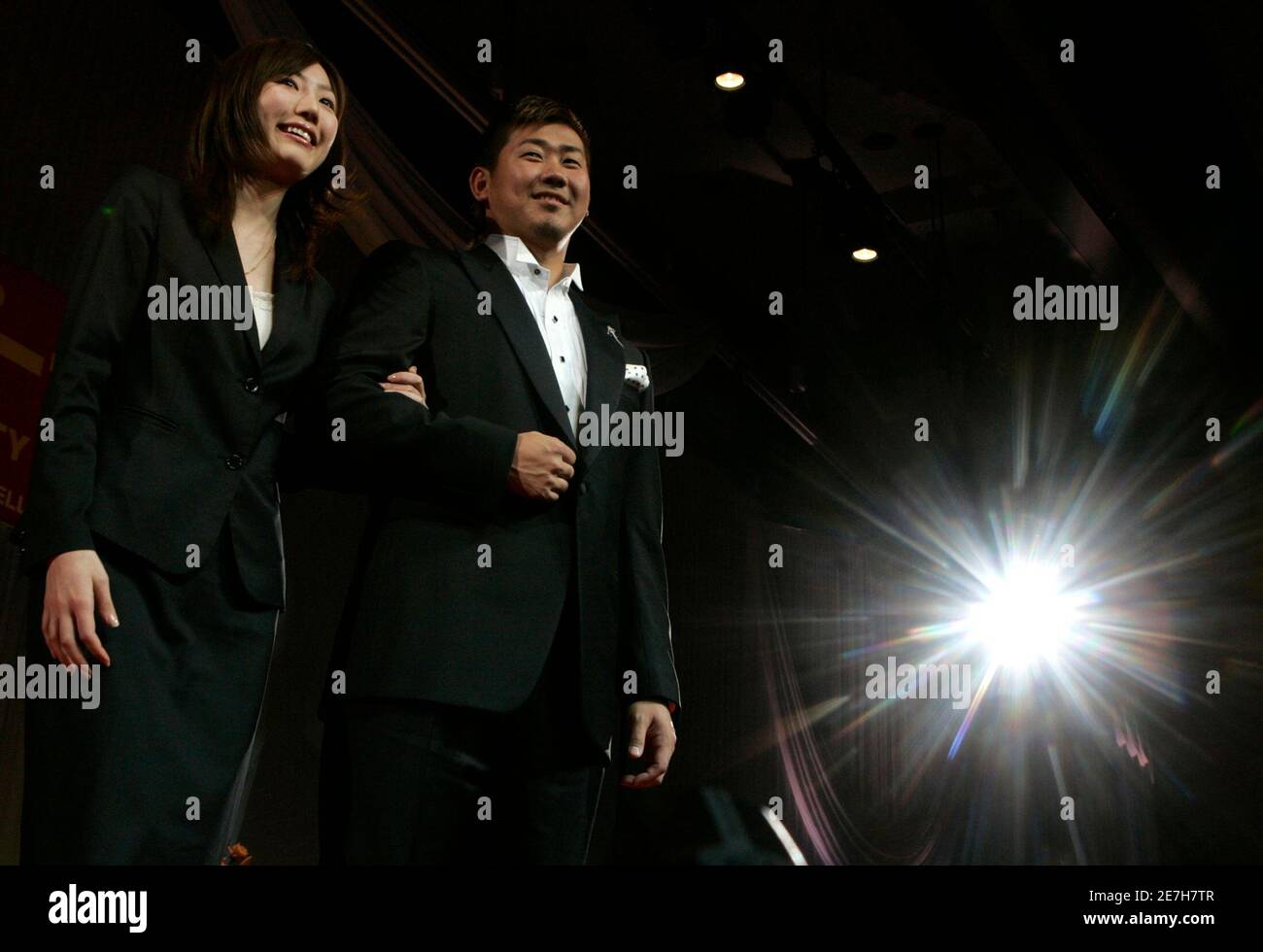 Boston Red Sox pitcher Daisuke Matsuzaka (R) of Japan poses with an  attendant at the best jewellery wearer award ceremony during the 19th  International Jewellery Tokyo 2008 fair in Tokyo January 23,