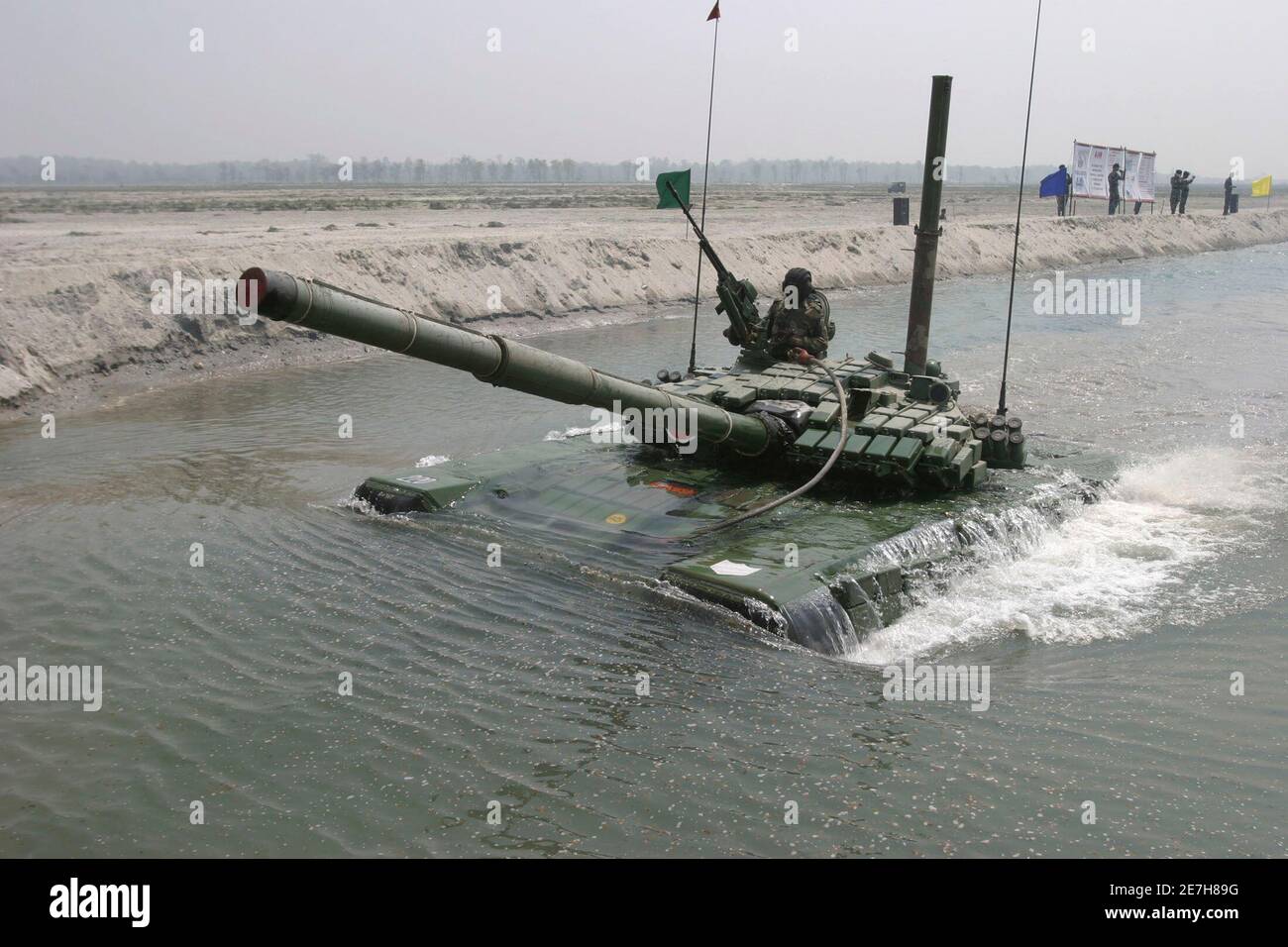 An Indian army T-72 tank crosses the Gish river during a military exercise at Teesta firing range, about 42 km (26 miles) north from the northeastern Indian city of Siliguri, March 15, 2008.   REUTERS/Rupak De Chowdhuri (INDIA) Stock Photo